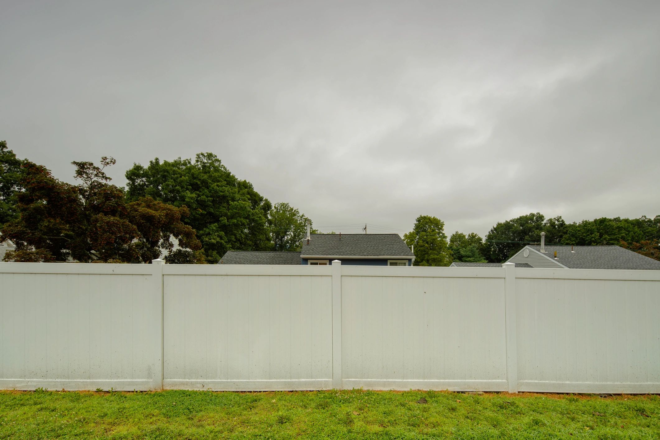 White picket fence near a home