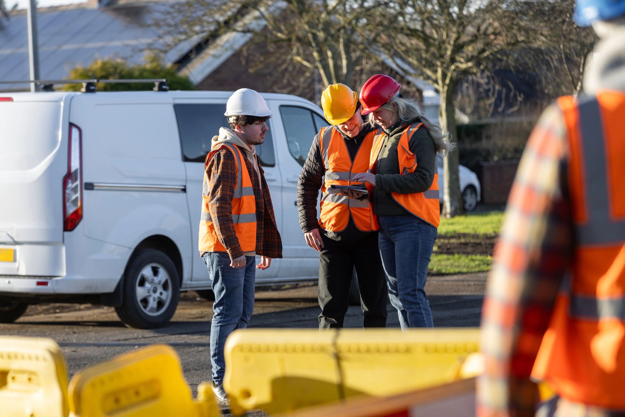 Construction team discussing project details on site