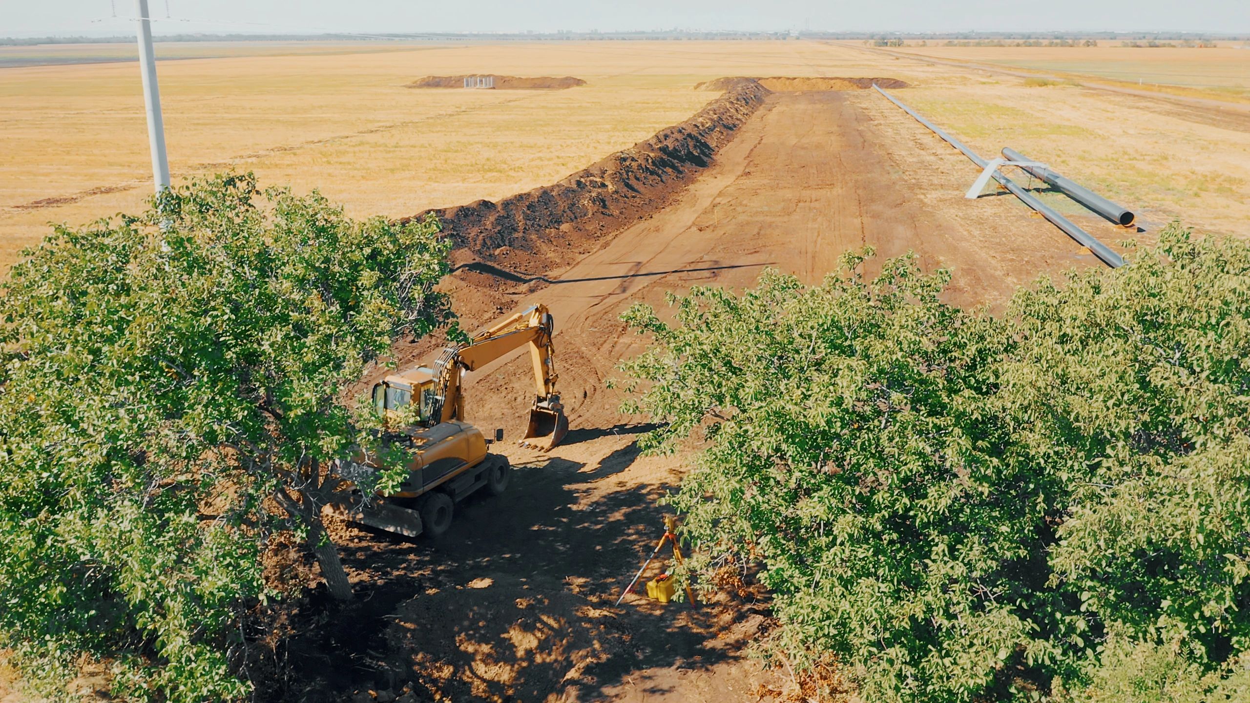 Excavator trenching for underground utility installation